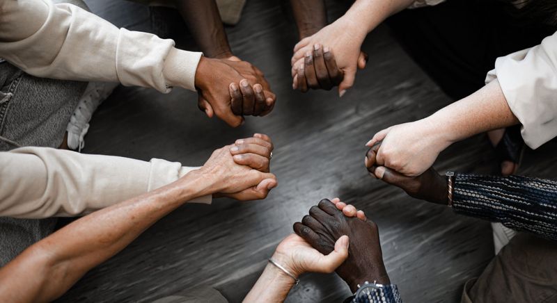 People holding hands in a circle