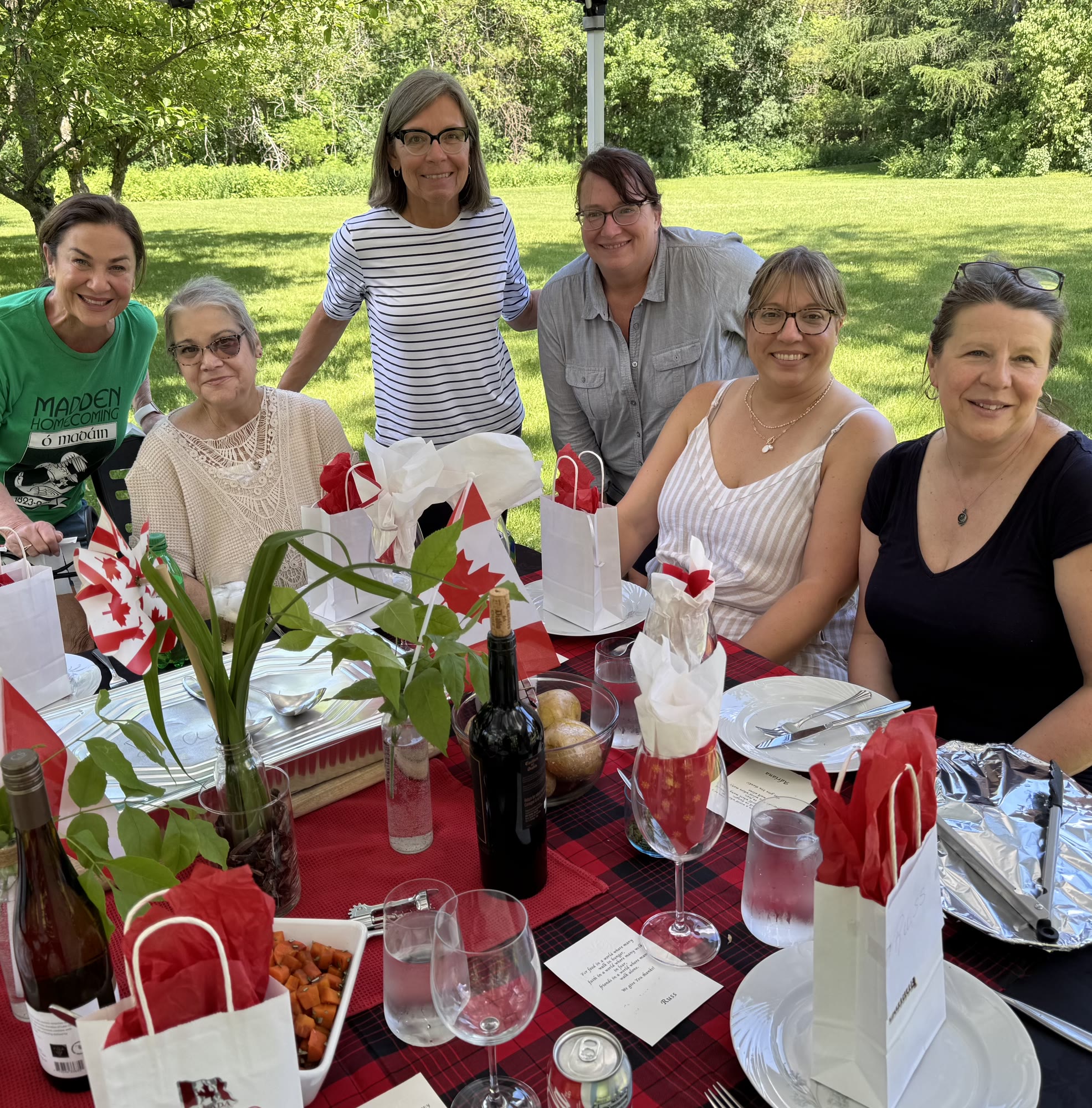 Friends gathered around an outdoor table in Toronto, Canada